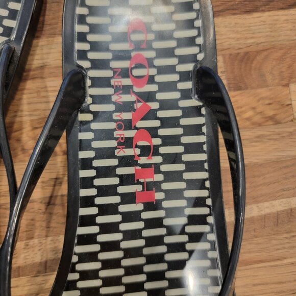 Coach Landon jelly flip flops in black with a gold bow and white pattern. - Picture 4 of 12